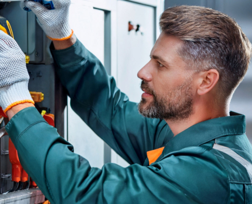 Technician performing maintenance on a commercial refrigeration unit.